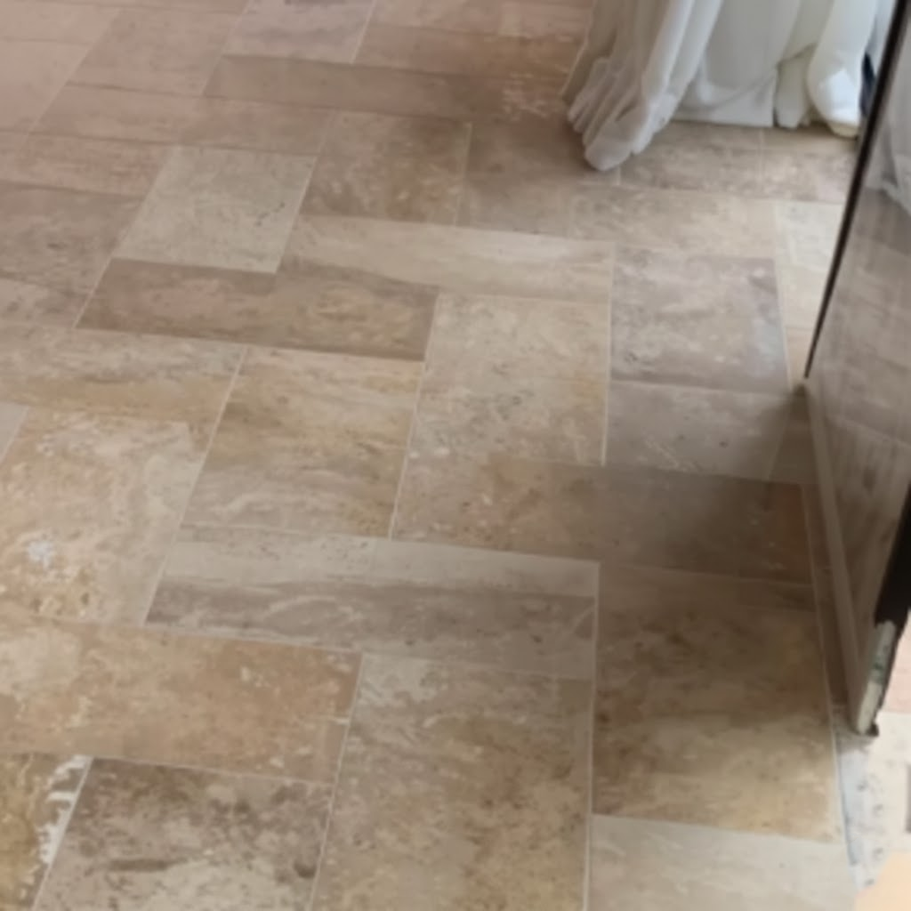 Interior flooring with large-format natural limestone slabs in beige and tan organic finish.png
