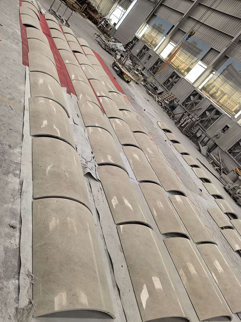 Custom curved marble slabs in factory production for architectural decoration projects.jpg